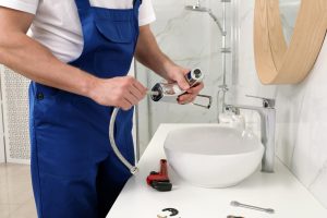 Plumber fixing water tap in bathroom Sarasota, FL