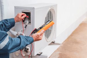 Person checking a malfunctioning HVAC system Bradenton, FL