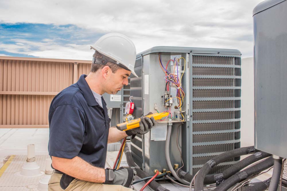 Technician tinkering with an HVAC system