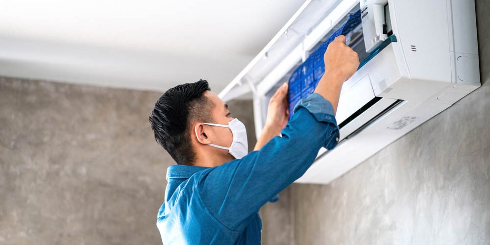 AC tech doing AC cleaning